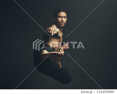 Martial arts, kick and man in portrait, training and fitness for wellbeing in studio backdrop for karate or capoeira. Male person, foot and motion in black background for sports, wellness or workout 119293669