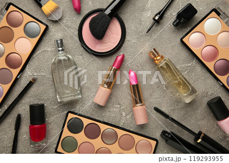 Set of decorative cosmetics with roses on grey background. Vertical photo Set of decorative cosmetics with roses on grey background. Vertical photo 119293955