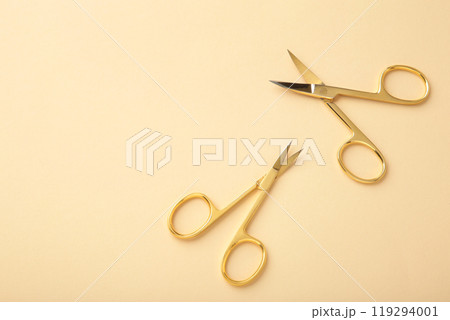 Scissors for manicure woman nails on beige background with copy space 119294001