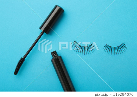 Black eyelashes and mascara on blue background 119294070