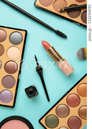 Decorative cosmetics on blue background. Makeup. Vertical photo. Decorative cosmetics on blue background. Makeup. Vertical photo. 119294095