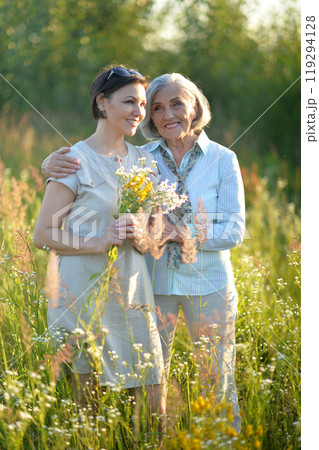 An elderly woman with her daughter in the park in summer 119294128