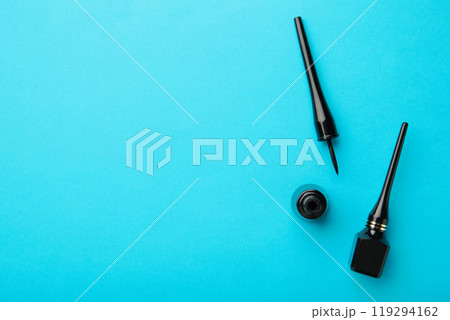 Eyeliners on blue background with copy space. Top view 119294162