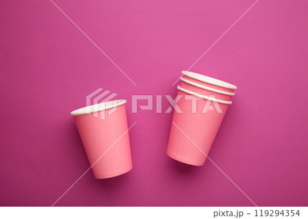 Disposable paper cups on pink background. Top view. 119294354