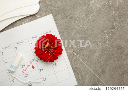 Menstruation calendar with cotton tampons and pads on grey background. Woman critical days, woman hygiene protection. Menstrual pain 119294355