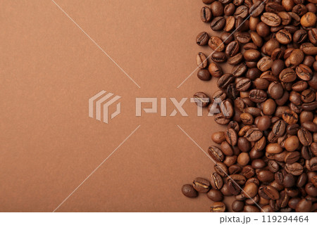 Coffee beans on brown background. Top view. Coffee beans on brown background. Top view. 119294464