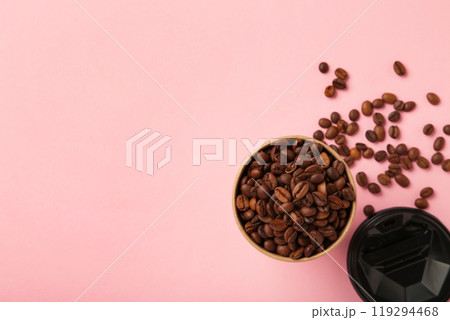 Coffee beans and paper coffee cup on pink background. Coffee beans and paper coffee cup on pink background. 119294468