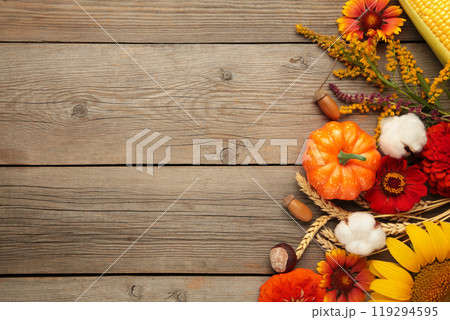 Autumn composition. Frame made of fresh flowers on grey wooden background. Flat lay, top view, copy space. Thanksgiving day 119294595