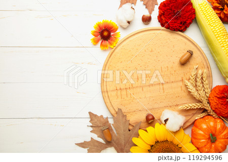 Autumn composition. Frame made of fresh flowers on white wooden background. Flat lay, top view, copy space. Thanksgiving day with copy space. 119294596