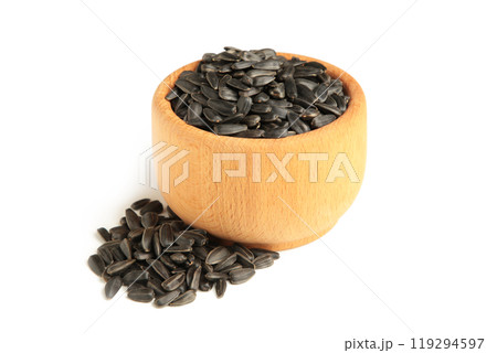 Sunflower seeds in wooden bowl isolated on white background. 119294597