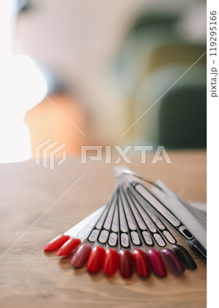 Nail polish samples in different bright colors. Colorful nail lacquer manicure swatches. Top view of nail art wheel palette Nail polish samples in different bright colors. Colorful nail lacquer manicure swatches. Top view of nail art wheel palette 119295166