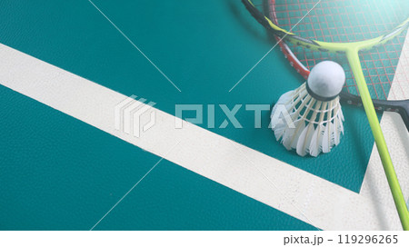 White badminton shuttlecocks and badminton rackets on green floor indoor badminton court. Concept for badminton competition and its lovers. White badminton shuttlecocks and badminton rackets on green floor indoor badminton court. Concept for badminton competition and its lovers. 119296265