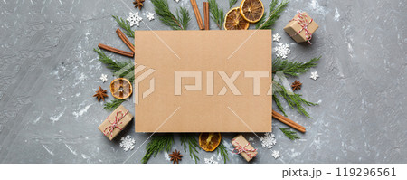 Flat lay Christmas composition. square Paper blank, pine tree branches, christmas decorations on Colored background. Top view, copy space for text Flat lay Christmas composition. square Paper blank, pine tree branches, christmas decorations on Colored background. Top view, copy space for text 119296561