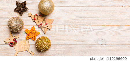 New Year composition made of baubles, reindeer and other decorations on wooden background. Christmas time concept with empty space for your design 119296600