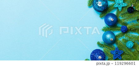 Set of festive balls, fir tree and Christmas decorations on colorful background. Top view of New Year ornament concept with copy space 119296601