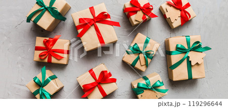 Colored craft gift boxes with colorful ribbons on colored background. Collection of Christmas present boxes 119296644