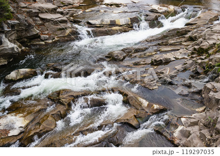 Mountain river with stones. Rafting river in forest. Splashy fast river texture. Natural water background Mountain river with stones. Rafting river in forest. Splashy fast river texture. Natural water background 119297035
