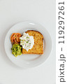 A beautifully arranged white plate, generously topped with a delightful combination of toast, fresh guacamole, salmon and a dollop of whipped cream 119297261