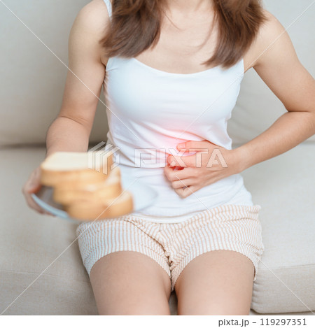 Gluten intolerance, Gluten free and celiac disease or wheat allergy concept. woman hold Bread and having abdominal pain after eat gluten. stomach ache, Nausea, Bloating, Gas, Diarrhea and Skin rash Gluten intolerance, Gluten free and celiac disease or wheat allergy concept. woman hold Bread and having abdominal pain after eat gluten. stomach ache, Nausea, Bloating, Gas, Diarrhea and Skin rash 119297351