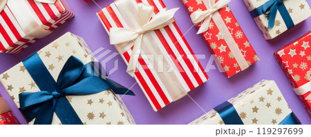 A lot of Christmas gift boxes in colored paper decorated on table, Top view close up. Many present New Year gift 119297699
