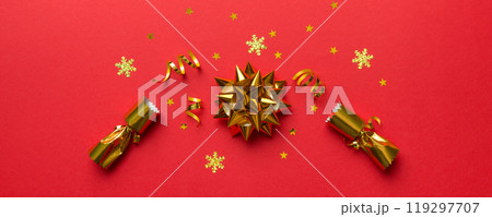 Christmas crackers with shiny confetti on color background, top view, copy space Christmas crackers with shiny confetti on color background, top view, copy space 119297707