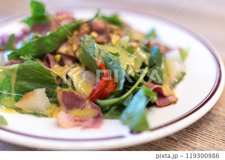 salad of fresh vegetables, greens and beef with sauce 119300986