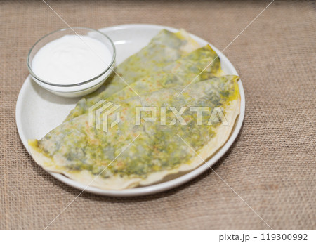 national cuisine, kutab with greens on a plate with kefir sauce national cuisine, kutab with greens on a plate with kefir sauce 119300992