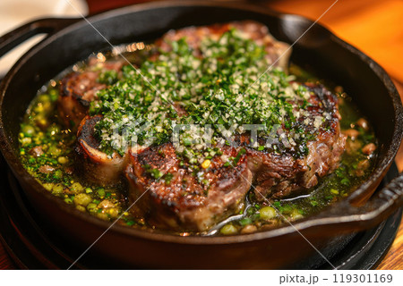 Traditional braised Italian ossobuco alla Milanese served in a cast-iron design stewpot Traditional braised Italian ossobuco alla Milanese served in a cast-iron design stewpot 119301169