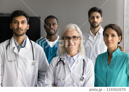 Professional medical team with senior female leader look at camera Professional medical team with senior female leader look at camera 119302070