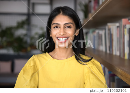 Happy beautiful young Indian student woman posing in library Happy beautiful young Indian student woman posing in library 119302101