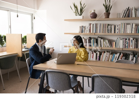Serious multiethnic boss and manager discussing project strategy Serious multiethnic boss and manager discussing project strategy 119302318