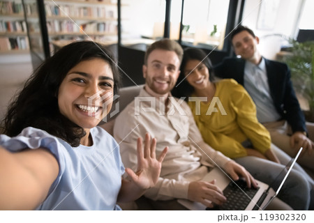 Happy young Indian manager girl taking selfie with office friends 119302320