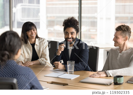 Happy cheerful Indian startup leader brainstorming on project Happy cheerful Indian startup leader brainstorming on project 119302335