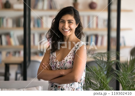 Happy beautiful young Indian manager woman posing in library Happy beautiful young Indian manager woman posing in library 119302410