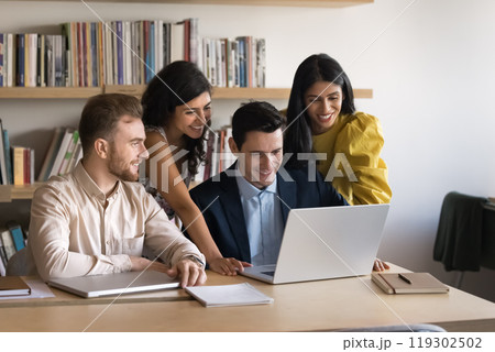 Happy diverse business team using laptop together 119302502