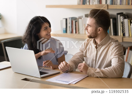 Happy multiethnic colleagues discussing startup marketing strategy 119302535