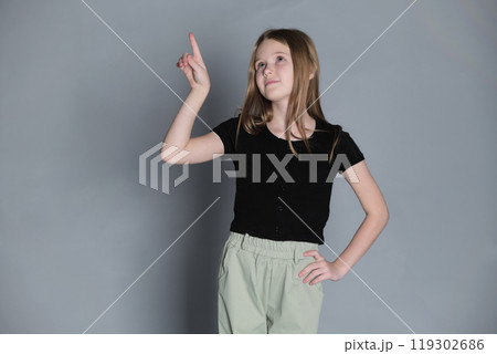 Posing playfully, a girl with arm extended. Captures the natural expressiveness and drama found in youth. Posing playfully, a girl with arm extended. Captures the natural expressiveness and drama found in youth. 119302686