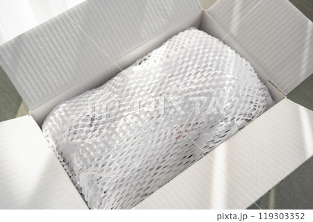 Corrugated white paper for safe transportation, in which the goods brought by the courier delivery service are wrapped, environmental packaging concept Corrugated white paper for safe transportation, in which the goods brought by the courier delivery service are wrapped, environmental packaging concept 119303352