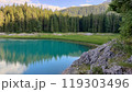 A large body of water that is completely surrounded by trees and rocks 119303496