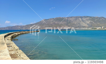 A large, expansive body of water with majestic mountains in the background A large, expansive body of water with majestic mountains in the background 119303498