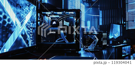 A computer monitor is on a desk near a computer case 119304041