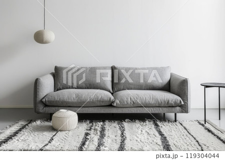 A cozy living room featuring a white couch and a vase of elegant pampas grass 119304044