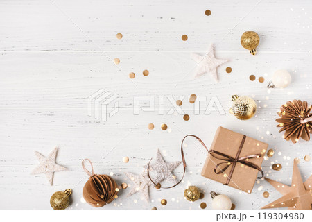 Festive Christmas background with gift box and Christmas decorations Festive Christmas background with gift box and Christmas decorations 119304980