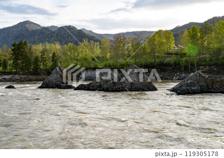 Elekmonar, Altai Republic, Suspension bridge over fast mountain river Katun. Sharp rocky islands in the middle of Katun river 119305178