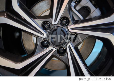 Detailed shot of a sleek black and silver alloy wheel on a motor vehicle 119305190