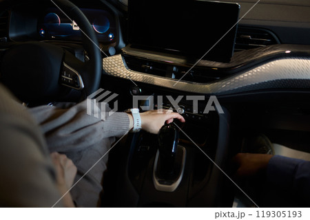 Closeup of a modern car steering wheel with control buttons for technology and convenience Closeup of a modern car steering wheel with control buttons for technology and convenience 119305193