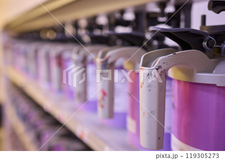 Colorful paint containers are arranged in a studio, showcasing creativity and artistic detail Colorful paint containers are arranged in a studio, showcasing creativity and artistic detail 119305273