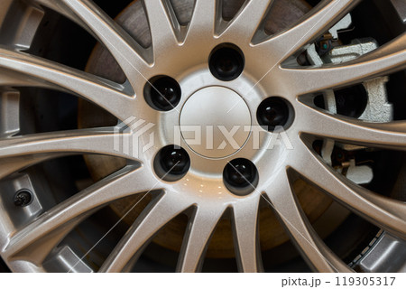 Detailed shot of a sleek black and silver alloy wheel on a motor vehicle Detailed shot of a sleek black and silver alloy wheel on a motor vehicle 119305317