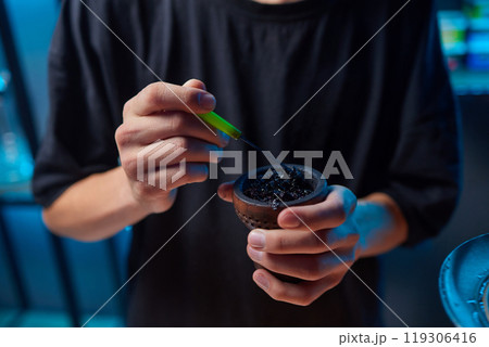 Person holding a hookah at a drinking establishment event 119306416