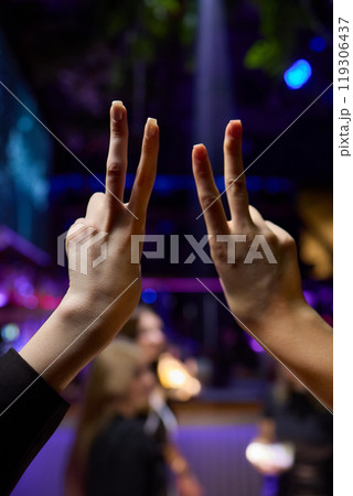 Hands Forming a Heart Shape in the Midst of a Vibrant and Joyful Celebration Event 119306437